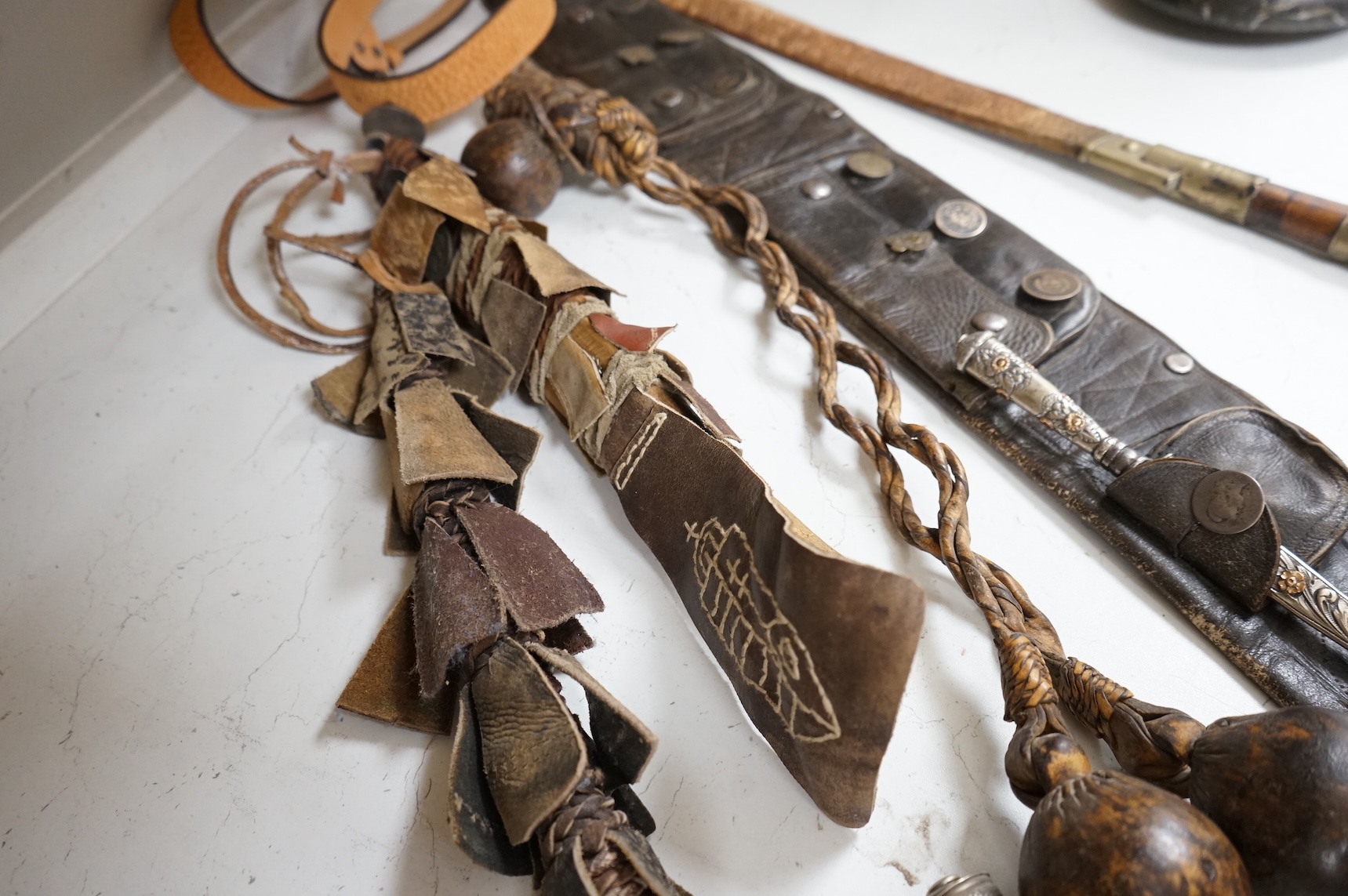 A group of Argentinian Gaucho spurs, bolas, bull whip, daggers and hanger, Longest 100cm